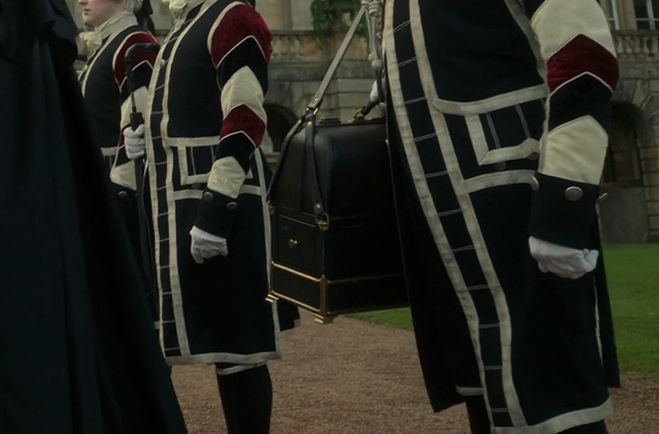 Some footmen in a line at the estate. The screenshot focuses on one who has Leopold's surgeon's bag over his shoulder.