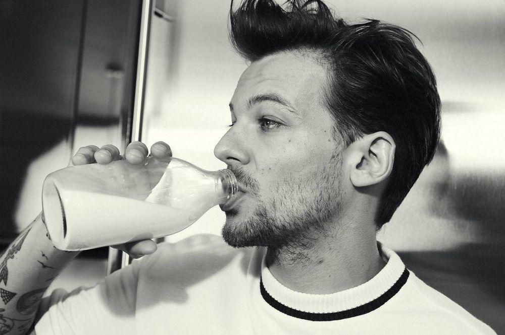 Louis Tomlinson drinking milk in full profile