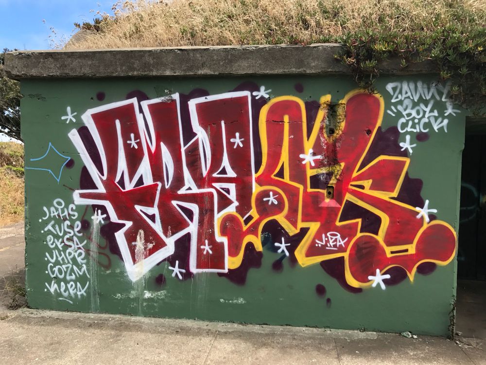 Graffiti art, interesting style, vivid colors with set on green background.