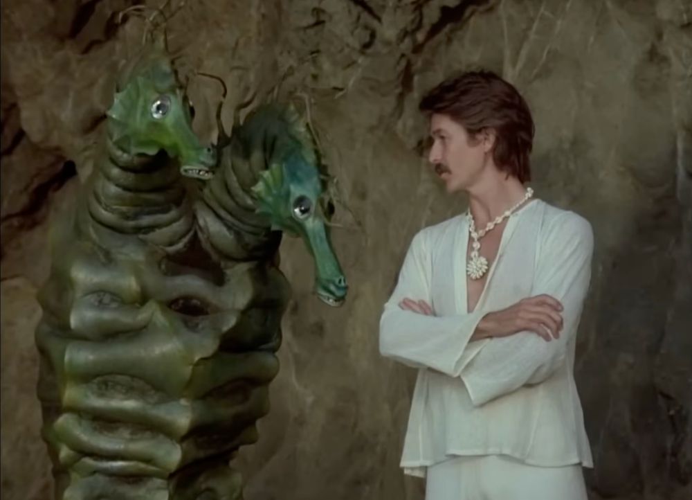 A mustache talking to Oscar, the two-headed seahorse