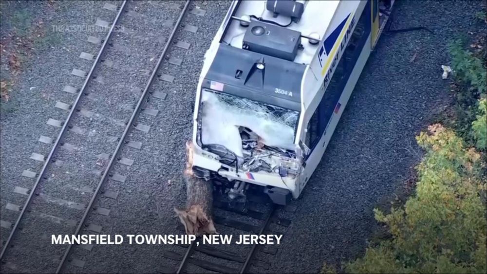 Operator dies and passengers injured as New Jersey commuter train hits tree