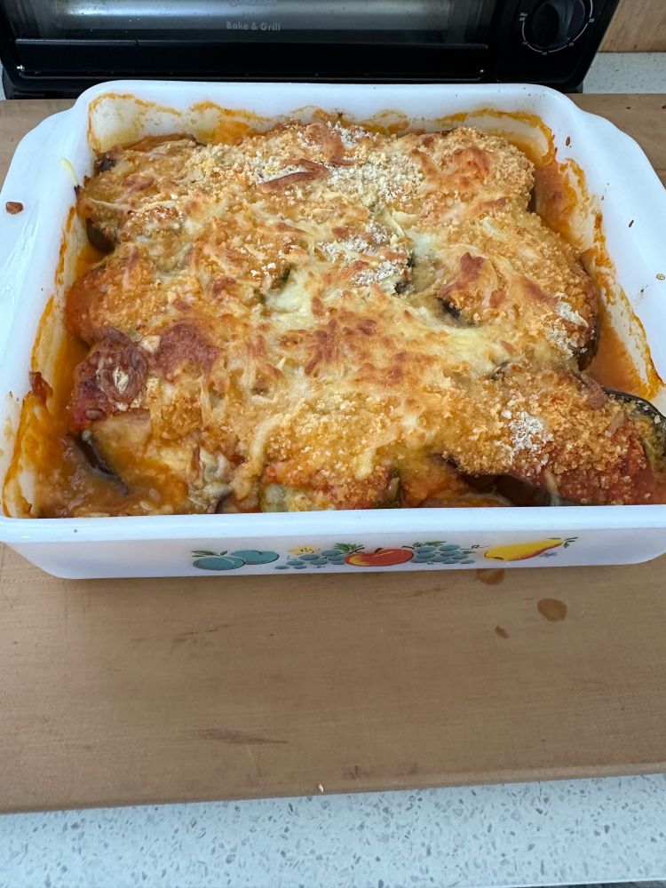 Eggplant parmigiana piping hot with a little missing from the corner. Yum.