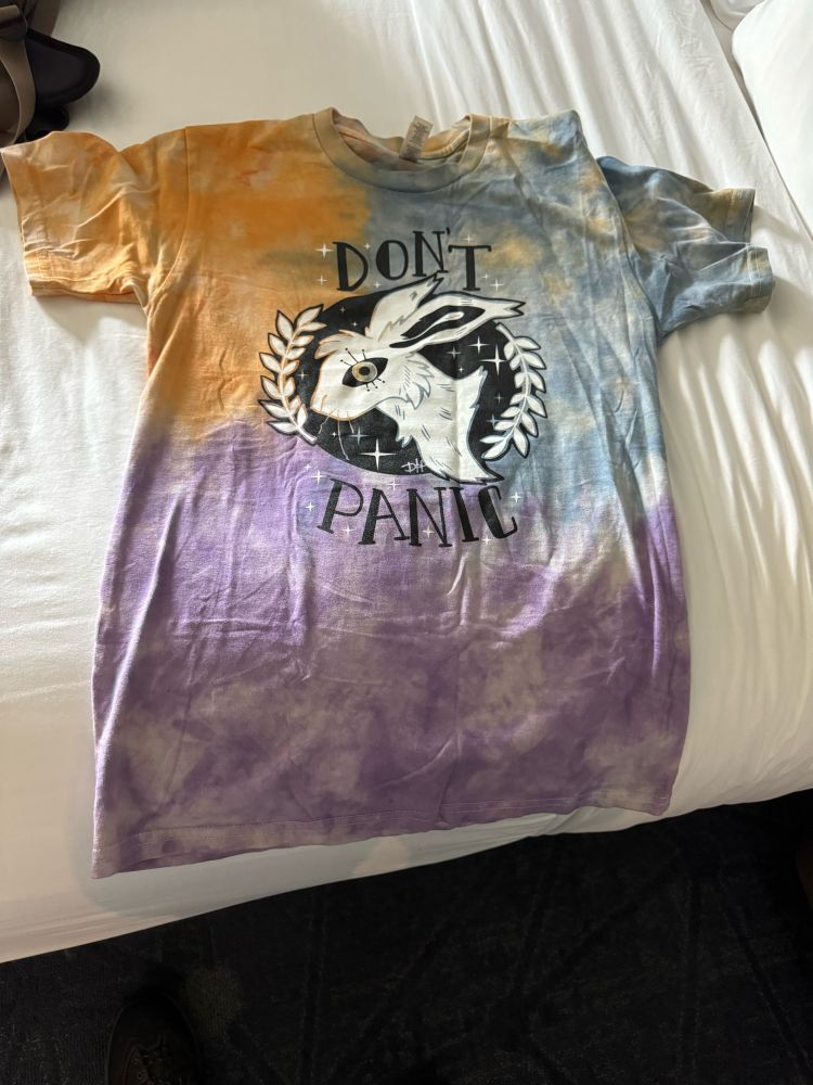 T-shirt with a picture of the head of a hare and the words “Don’t Panic” around it.