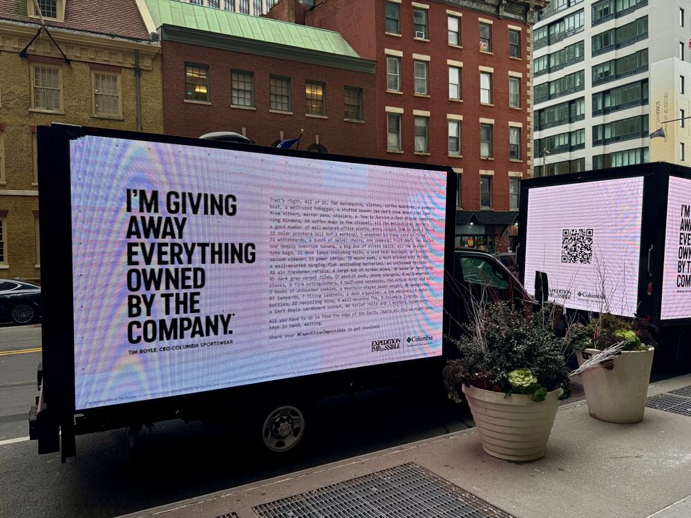 A digital billboard truck parked on a Lower Manhattan street showing an ad for Columbia Sportswear.
