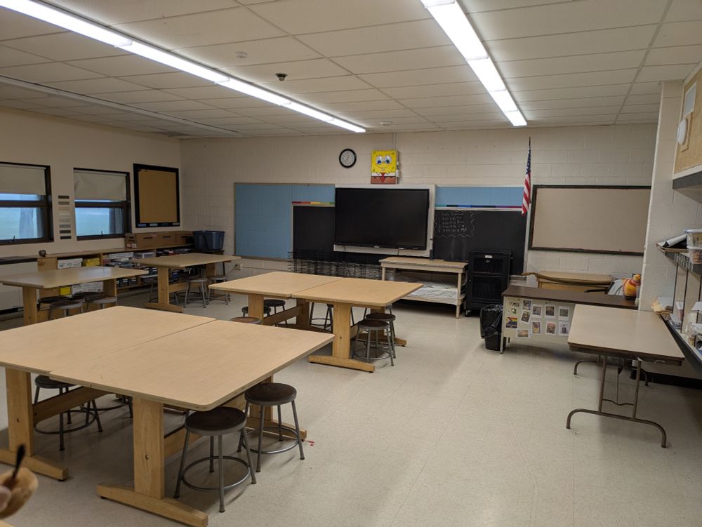 A clean art room with blank bulletin boards 