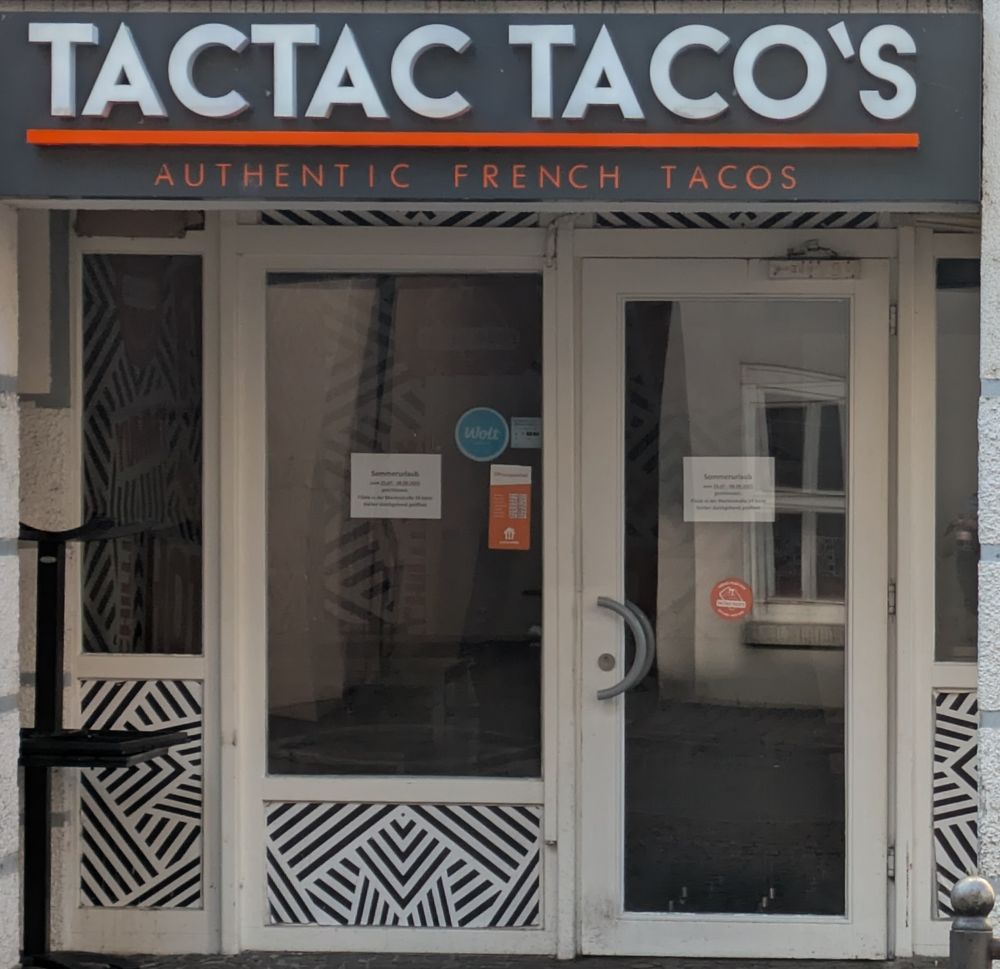 The front of a business with the sign "Tactac taco's Authentic French tacos"