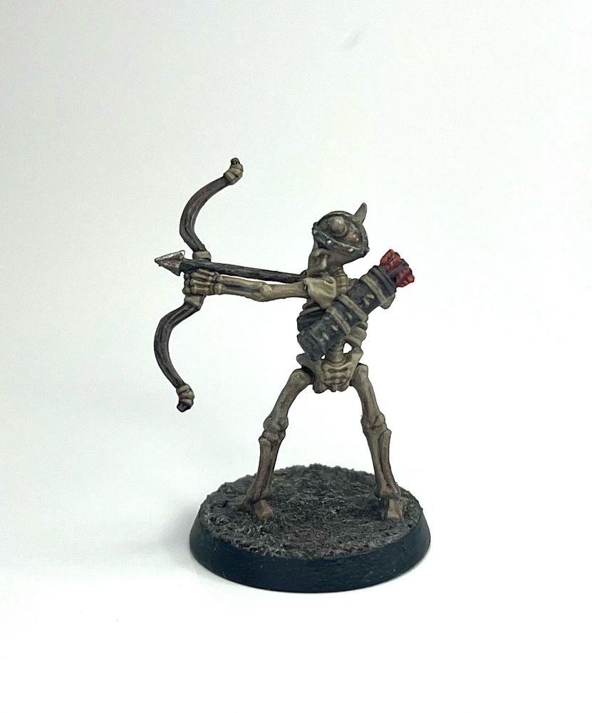The same archer skeleton miniature from the back, showing the leather quiver of arrows slung over its back.