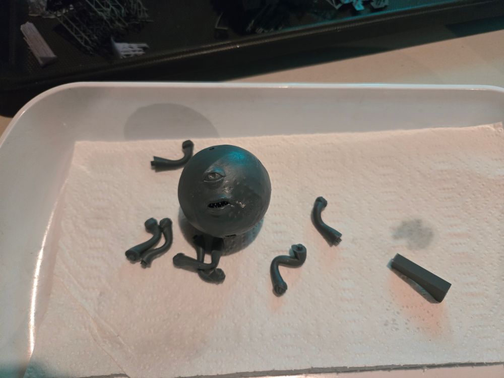 An unassembled 3d print of a beholder. 