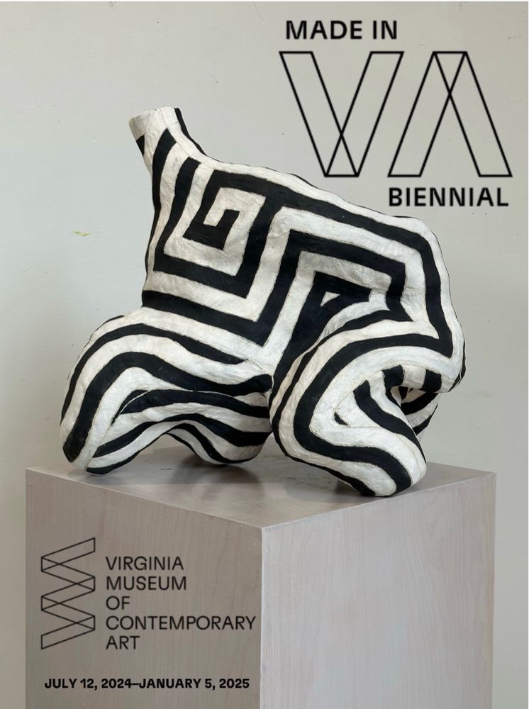 A black-and-white biomorphic sculpture sits on top a podium. With text that reads Virginia Museum of contemporary art.