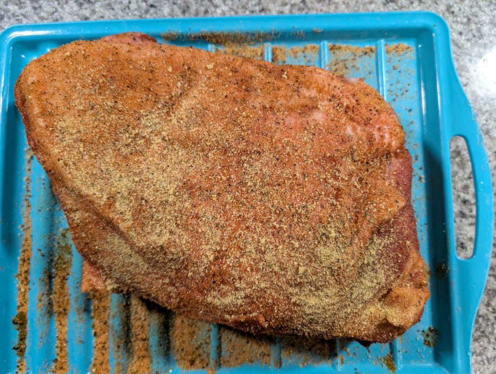 Seasoned pork butt ready for the smoker 