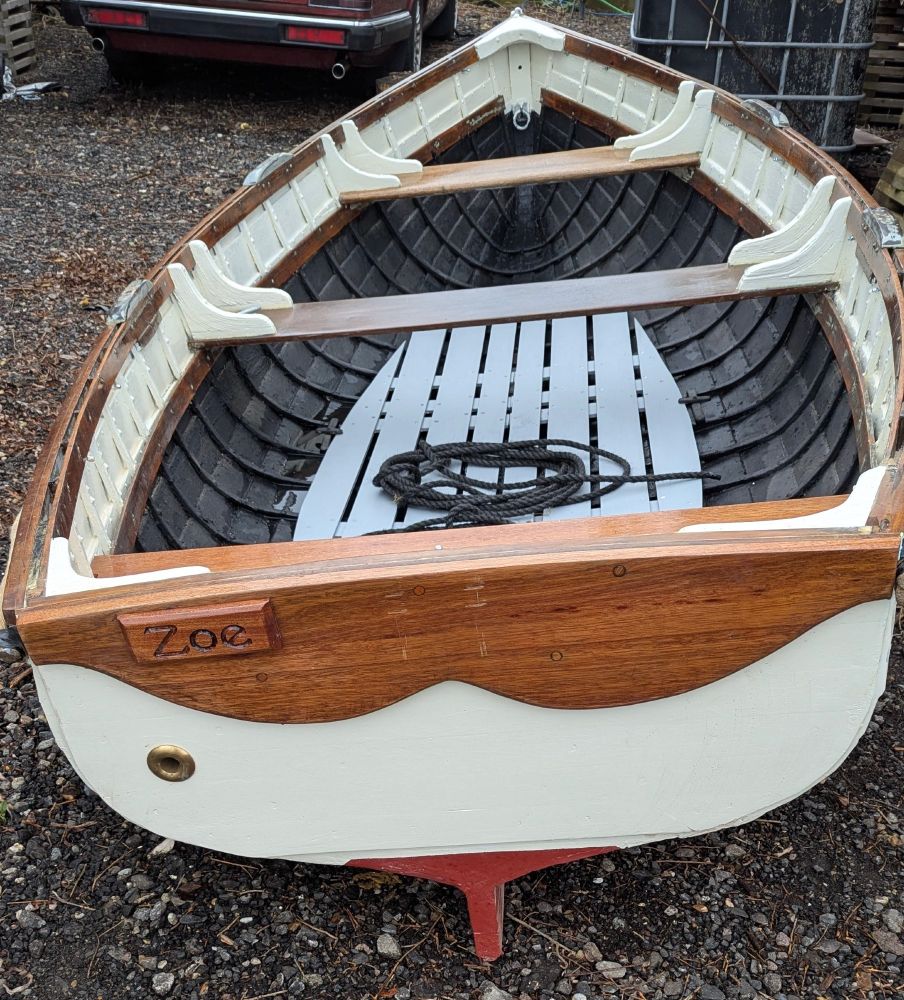 The same boat but repaired and mended and looking beautiful! Painted cream on the bottom and She shiney mahogany on top