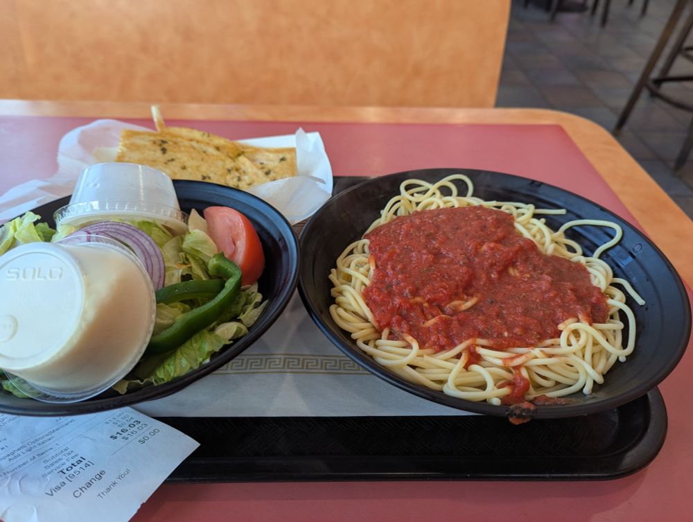pasta with marinara sauce, a side salad and garlic bread