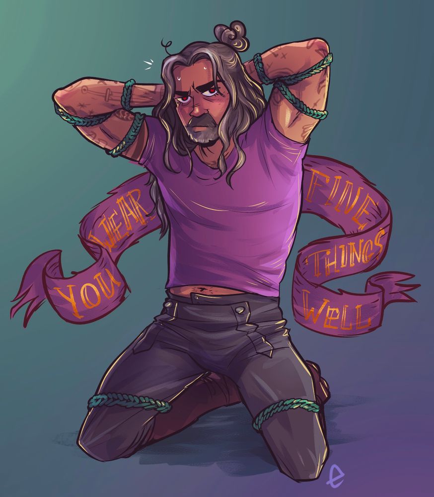 Ed teach on his knees in his purple shirt and leathers, with his arms tied up behind his head. Banner behind him says the iconic line “you wear fine things well”