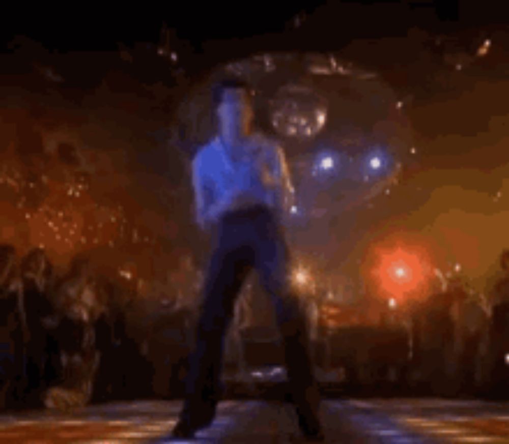 a man is dancing on a disco floor in front of a crowd .