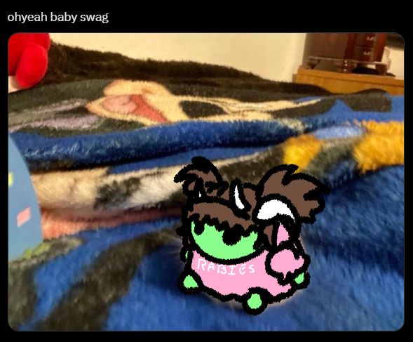 a drawing of my friends character miyoko wearing a "rabies" dress, as a tiny little creature on a blanket with the caption "ohyeah baby swag".