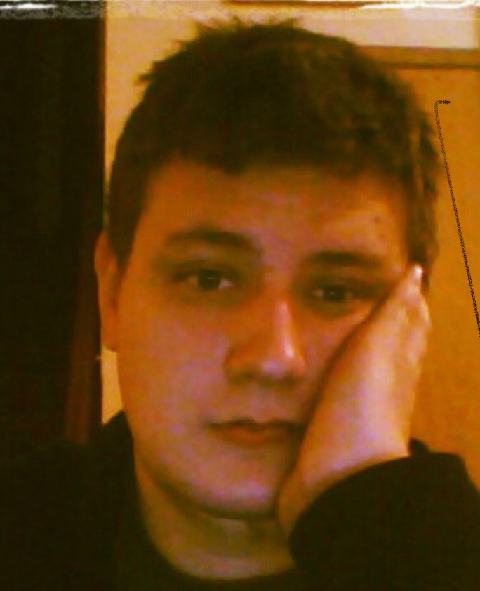 Me looking tired, leaning my face against my left hand, and looking directly into the camera.