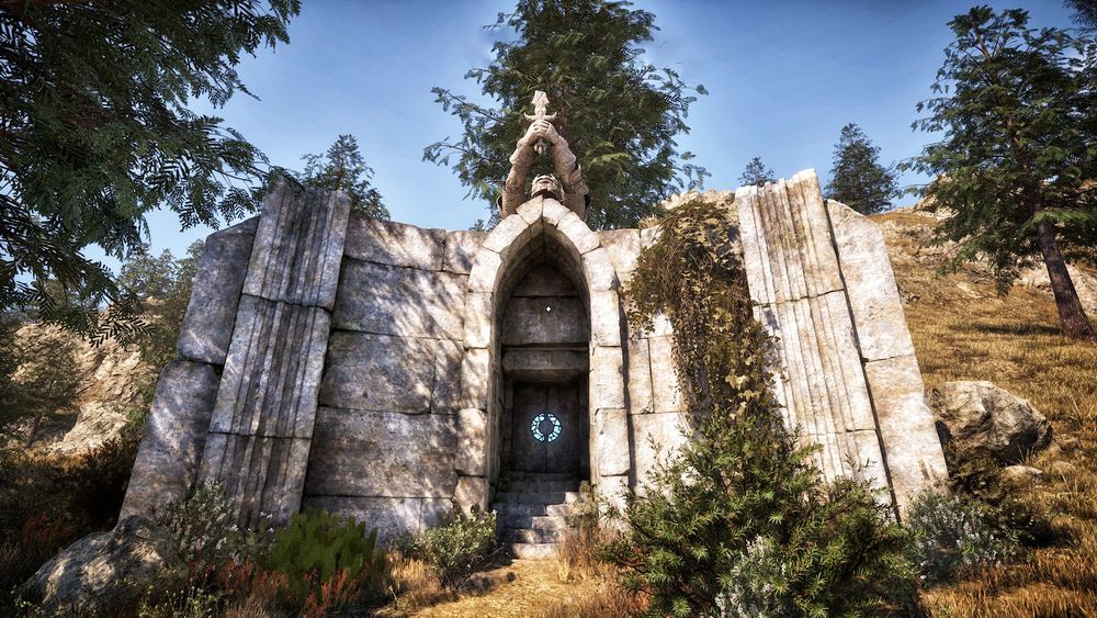 The stone entrance to an aylied ruin in Oblivion. The stone face is cracked and the door shines with a blue sigil