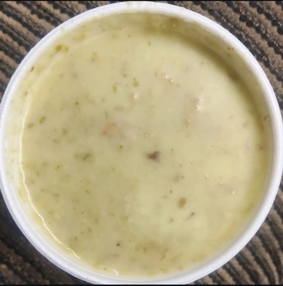 Panel C. We have the end result, the broth and lettuce were blended,  and chicken was added.  Garnished with croutons.