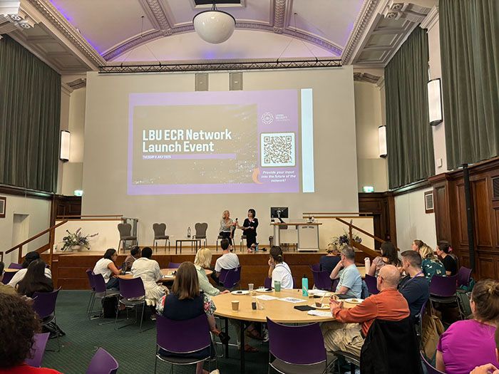Professor Silke Machold and Jaime Harrison on the stage at the Great Hall speaking to a full room of ECRs.