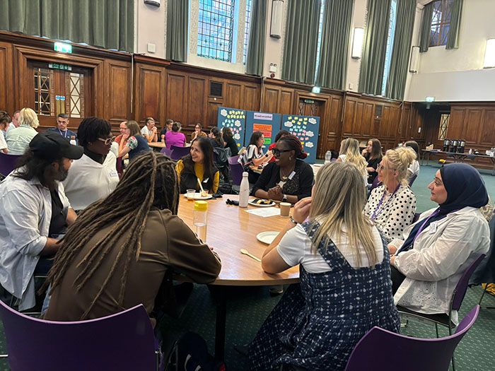 A full table of ECRs in the Great Hall engaged in a lively conversation.