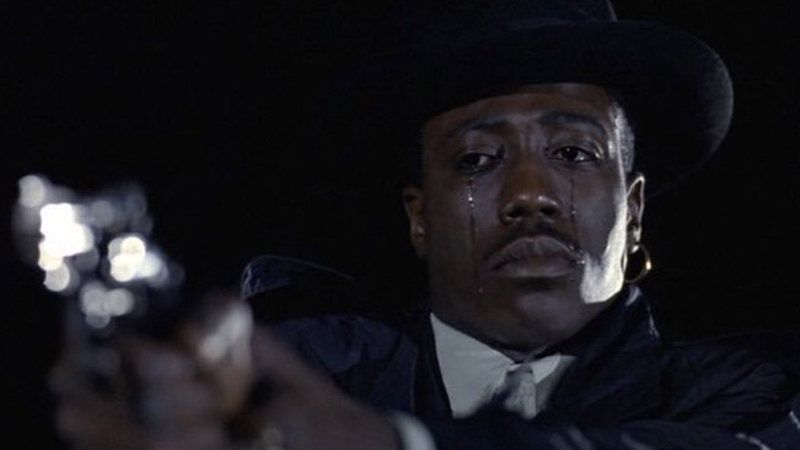 Wesley Snipes holding a gun while crying