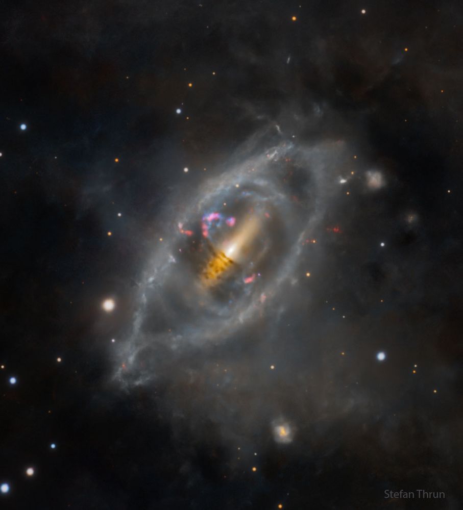 An unusual galaxy is shown that appears lens-like in overall shape yet has various rings of stars around the center. Please see the explanation for more detailed information.