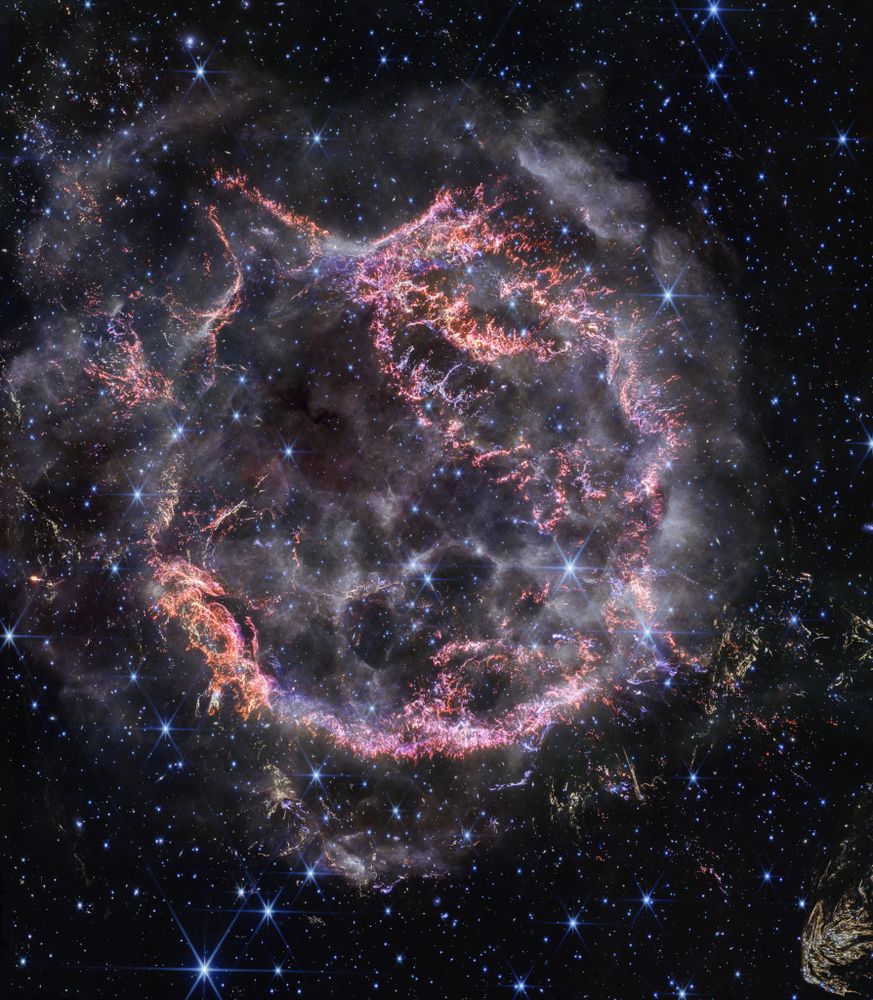 Massive stars in our Milky Way Galaxy live spectacular lives. Collapsing from vast cosmic clouds, their nuclear furnaces ignite and create heavy elements in their cores. After only a few million years for the most massive stars, the enriched material is blasted back into interstellar space where star formation can begin anew. The expanding debris cloud known as Cassiopeia A is an example of this final phase of the stellar life cycle. Light from the supernova explosion that created this remnant would have been first seen in planet Earth's sky about 350 years ago, although it took that light 11,000 years to reach us. This sharp NIRCam image from the James Webb Space Telescope shows the still hot filaments and knots in the supernova remnant. The whitish, smoke-like outer shell of the expanding blast wave is about 20 light-years across. A series of light echoes from the massive star's cataclysmic explosion are also identified in Webb's detailed images of the surrounding interstellar medium.