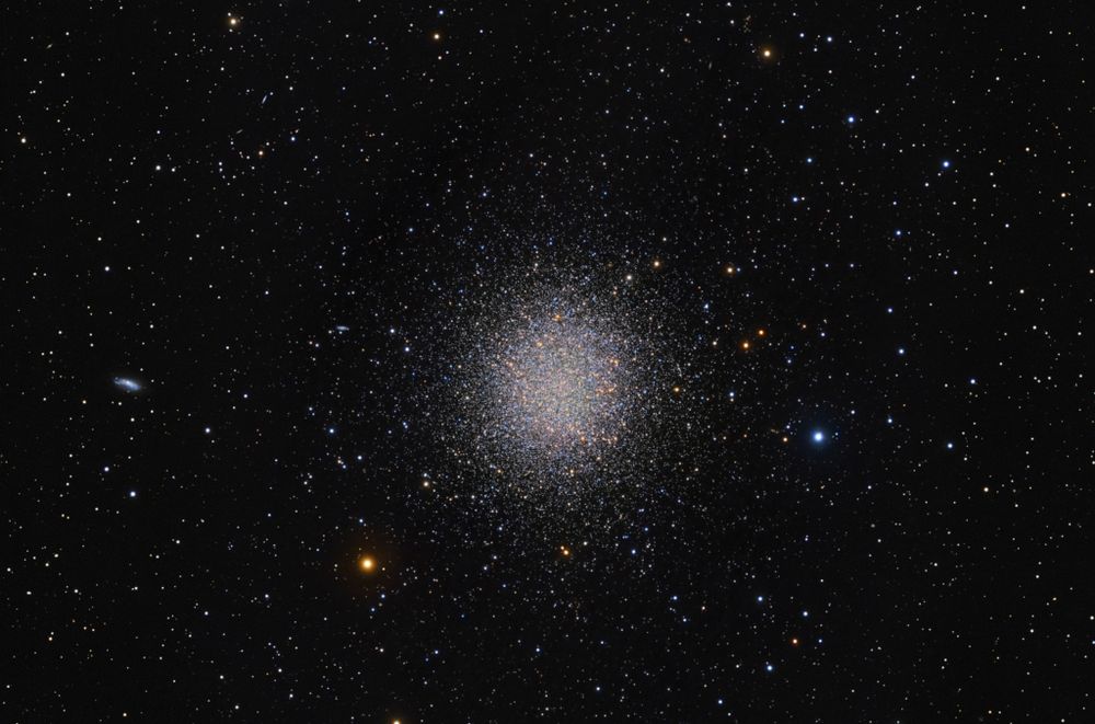 In 1716, English astronomer Edmond Halley noted, "This is but a little Patch, but it shews itself to the naked Eye, when the Sky is serene and the Moon absent." Of course, M13 is now less modestly recognized as the Great Globular Cluster in Hercules, one of the brightest globular star clusters in the northern sky. Sharp telescopic views like this one reveal the spectacular cluster's hundreds of thousands of stars. At a distance of 25,000 light-years, the cluster stars crowd into a region 150 light-years in diameter. Approaching the cluster core, upwards of 100 stars could be contained in a cube just 3 light-years on a side. For comparison with our neighborhood of the Milky Way, the closest star to the Sun is over 4 light-years away. Early telescopic observers of the great globular cluster also noted a curious convergence of three dark lanes with a spacing of about 120 degrees, seen here just below the cluster center. Known as the propeller in M13, the shape is likely a chance optical effect of the distribution of stars viewed from our perspective against the dense cluster core.