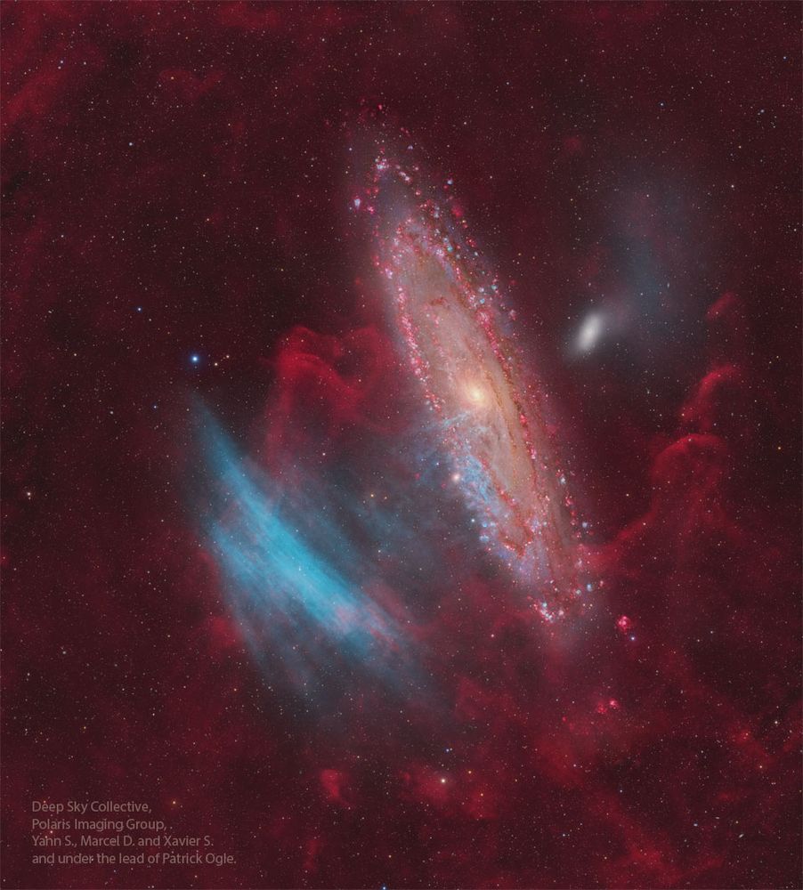 The Andromeda Galaxy is shown just right of center, while some unusual blue arcs appear to its left. Please see the explanation for more detailed information.
