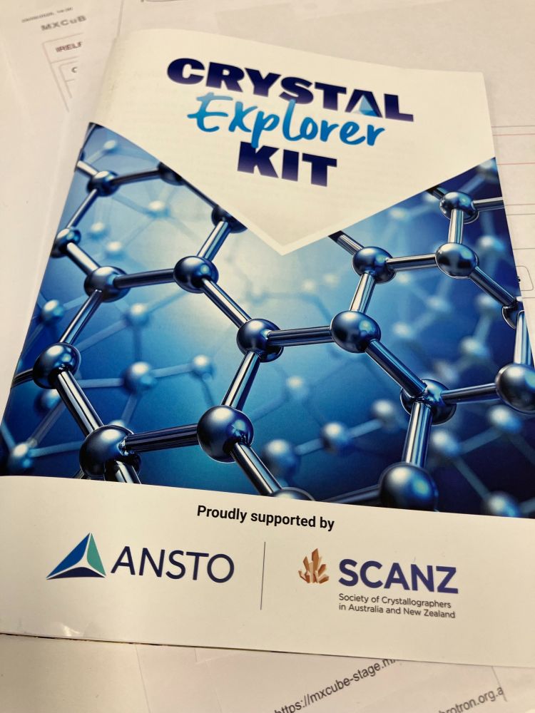 image of the front cover of a booklet, with the title 'Crystal Explorer Kit'.  The cover has images of connected atoms and logos from project supporters SCANZ and ANSTO