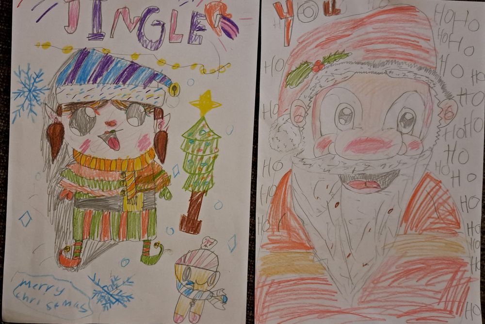 Portraits by my daughter, age 9, of Santa  and one of Santa's elf helpers (a girl elf called Jingle) in coloured pencil.