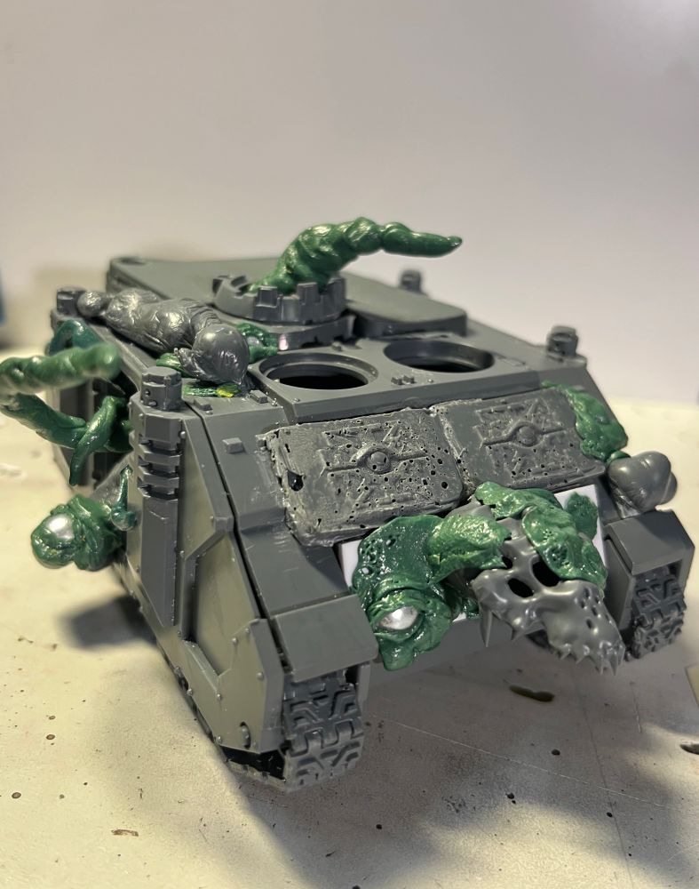 Green stuff sculpted custom work on Nurgle version of the Rhino tank miniature. Wh40k universe.