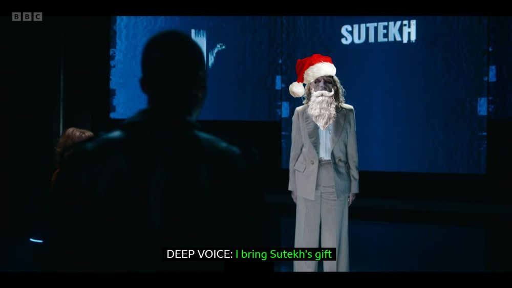 an edit of the scene when susan triad is taken over by Sutekh, altered so the subtitles only say "i bring sutekh's gift" with a santa hat and beard poorly photoshopped over her