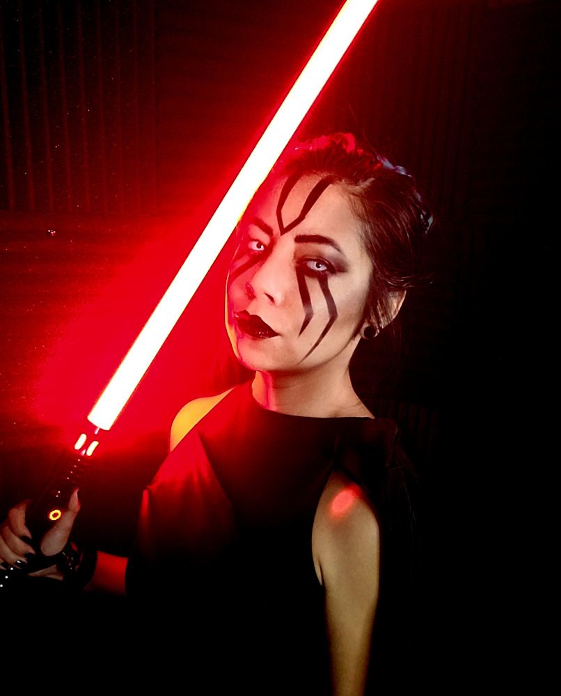 Caustic leans with a red lightsaber and Darth Maul inspired makeup.