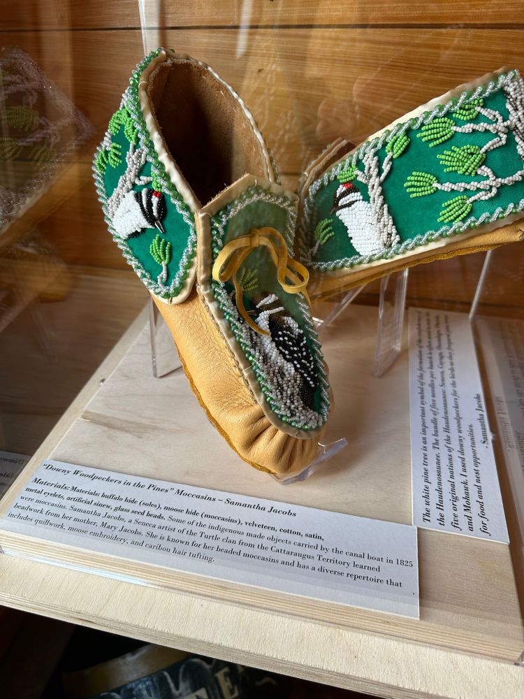 Mocassins with green beads and a woodpecker made out of beads