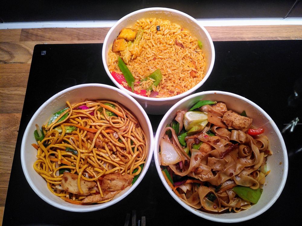 Singaporean Fried Rice with Plant Based Chicken
A fragrant and colourful fried rice dish inspired by the bold flavours of Singapore. Jasmine rice is stir-fried with a medley of fresh vegetables, then infused with aromatic curry spices and a hint of turmeric for a distinctive, golden hue.

Vegan chow mein
A deliciously savoury stir-fry of noodles, wok-tossed with a medley of fresh vegetables, including bell peppers, mushrooms, cabbage, and carrots. This vibrant dish is coated in a rich soy-based sauce, adding a perfect balance of umami and slight sweetness.

Vegan Pad Kee Mao with Tofu 
Known as "Drunken Noodles" . A spicy and savoury stir-fry with wide rice noodles, sautéed to perfection in a smoky, flavourful sauce made with soy sauce, garlic, and a hint of chili. This vegan version features vibrant vegetables like bell peppers, mushrooms, and onions, all tossed together with fresh Thai basil for an aromatic finish.