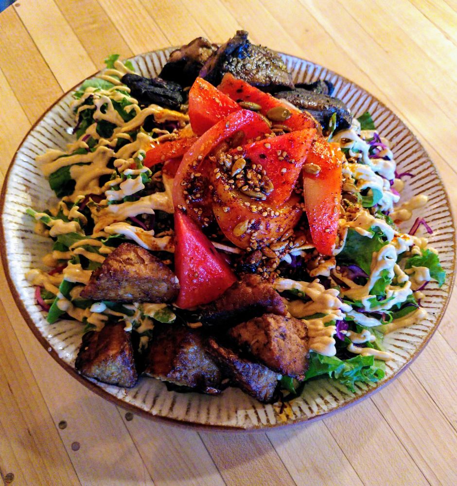 The Mexican Tostada
Pinto beans, quinoa, red cabbage, kale leaves, pickled onion, tostada top, hot pickle seasonal veg, tomato, Palm Greens chipotle crema, toasted seed guajillo oil - plus ginger tamari tempeh, roast portobello mushrooms and burnt habanero chile oil