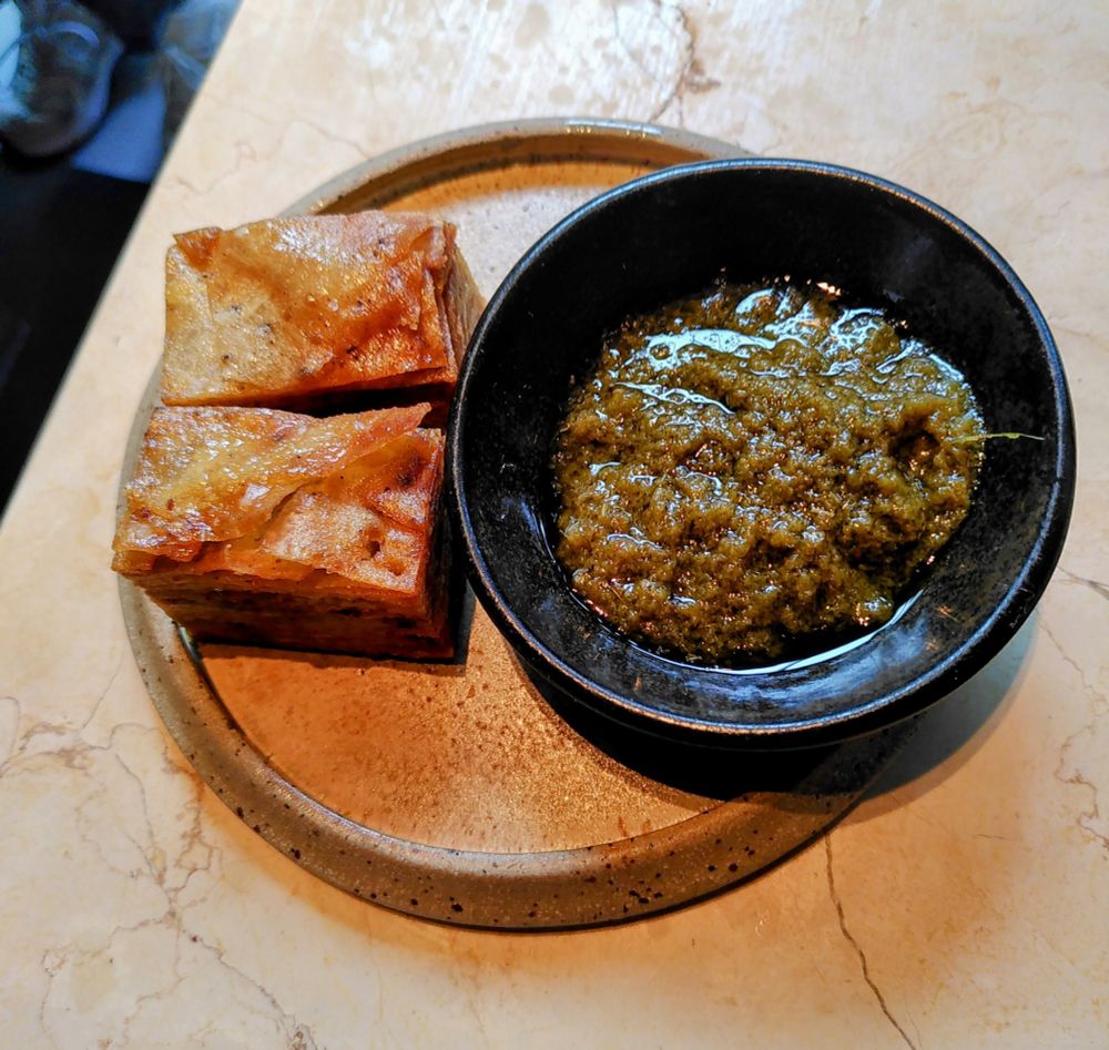 Pressed Yam w/ Green Shito
"Green Shito: a vibrant Ghanaian chilli sauce made with petite belle habanero peppers, onions, and aromatic spices, blended and slow cooked into a fiery paste with a fresh, punchy kick"