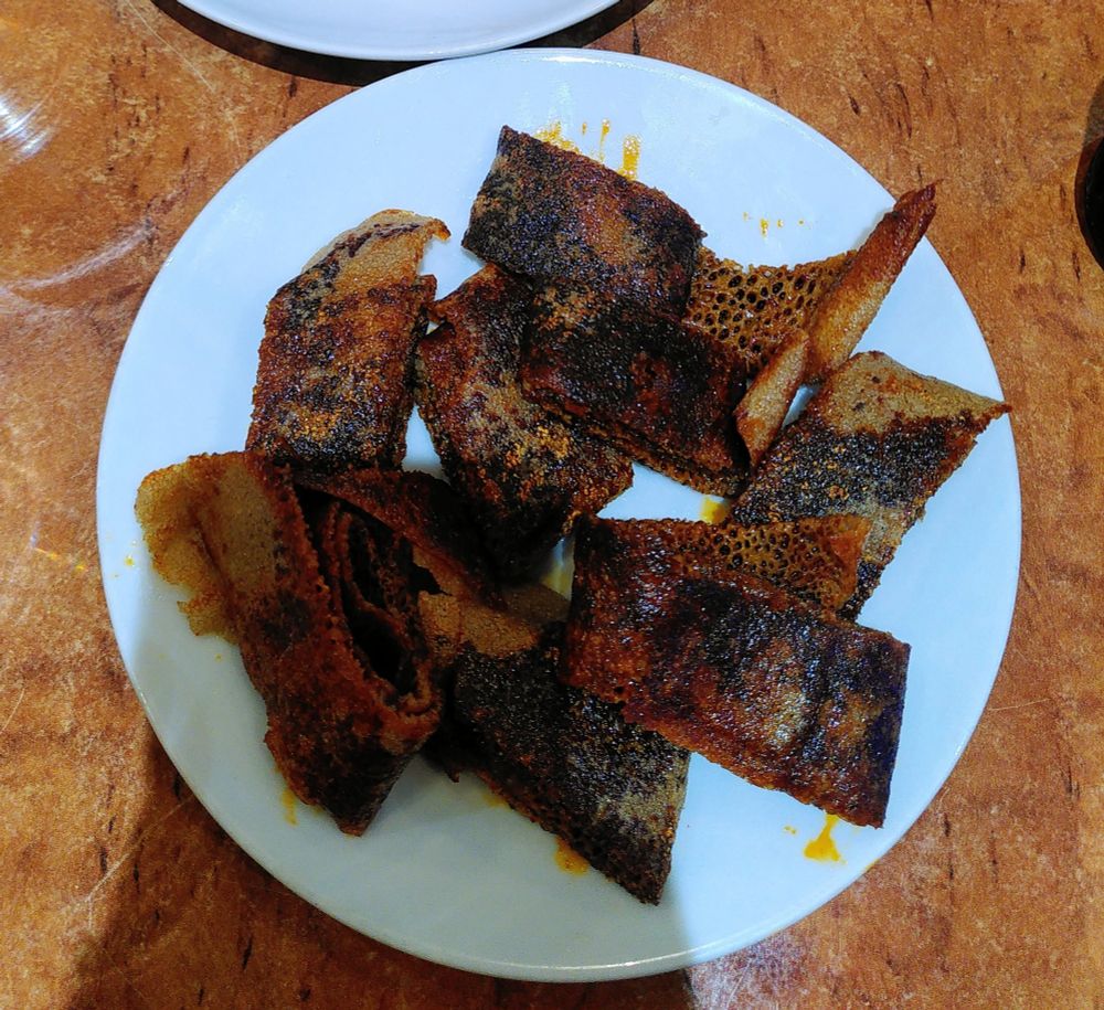 Kategna 
Crispy Injera seasoned with a mixture of chili and olive oil.