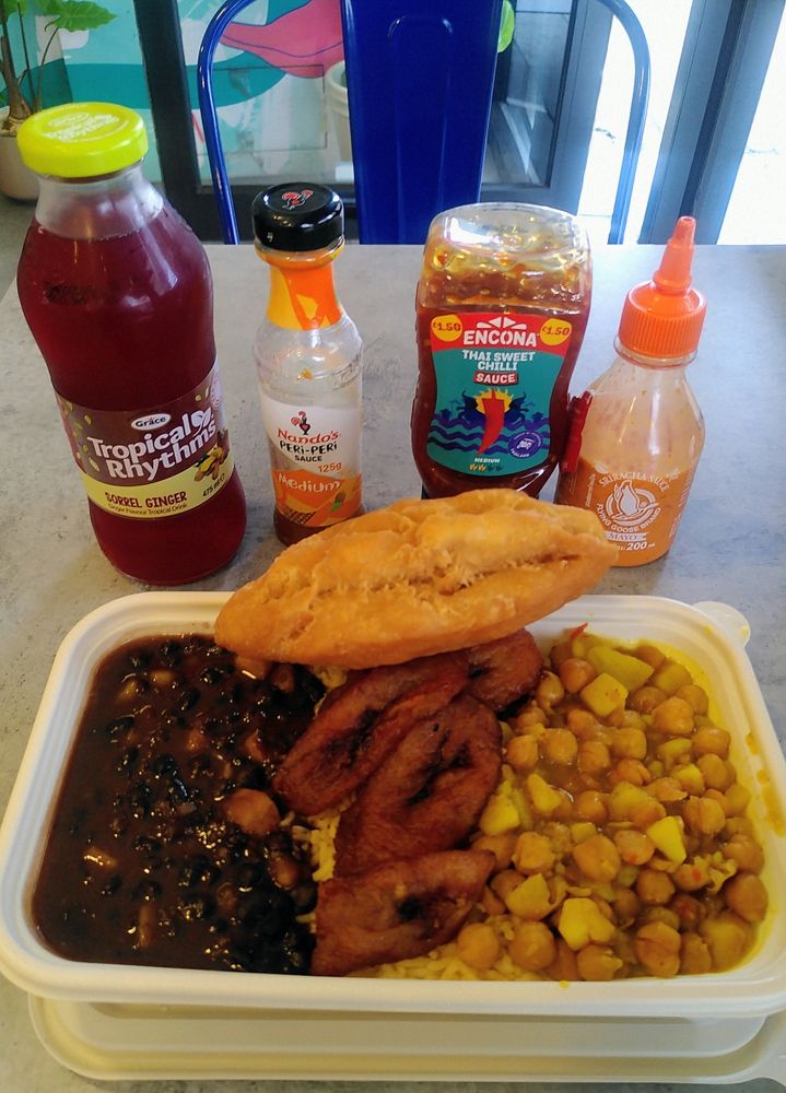 Black bean & sweet potato chilli, chickpea & potato curry, pumpkin rice, plantain, festival, with Sorrel & Ginger drink, and sauces