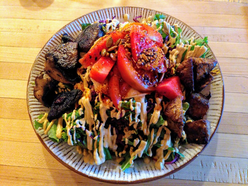 The Mexican Tostada
Pinto beans, quinoa, red cabbage, kale leaves, pickled onion, tostada top, hot pickle seasonal veg, tomato, Palm Greens chipotle crema, toasted seed guajillo oil - plus ginger tamari tempeh, roast portobello mushrooms and burnt habanero chile oil