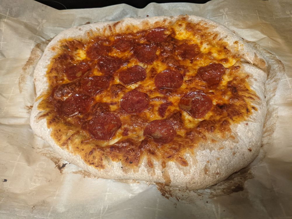 a homemade pepperoni and cheese pizza with massive wonky stuffed crust