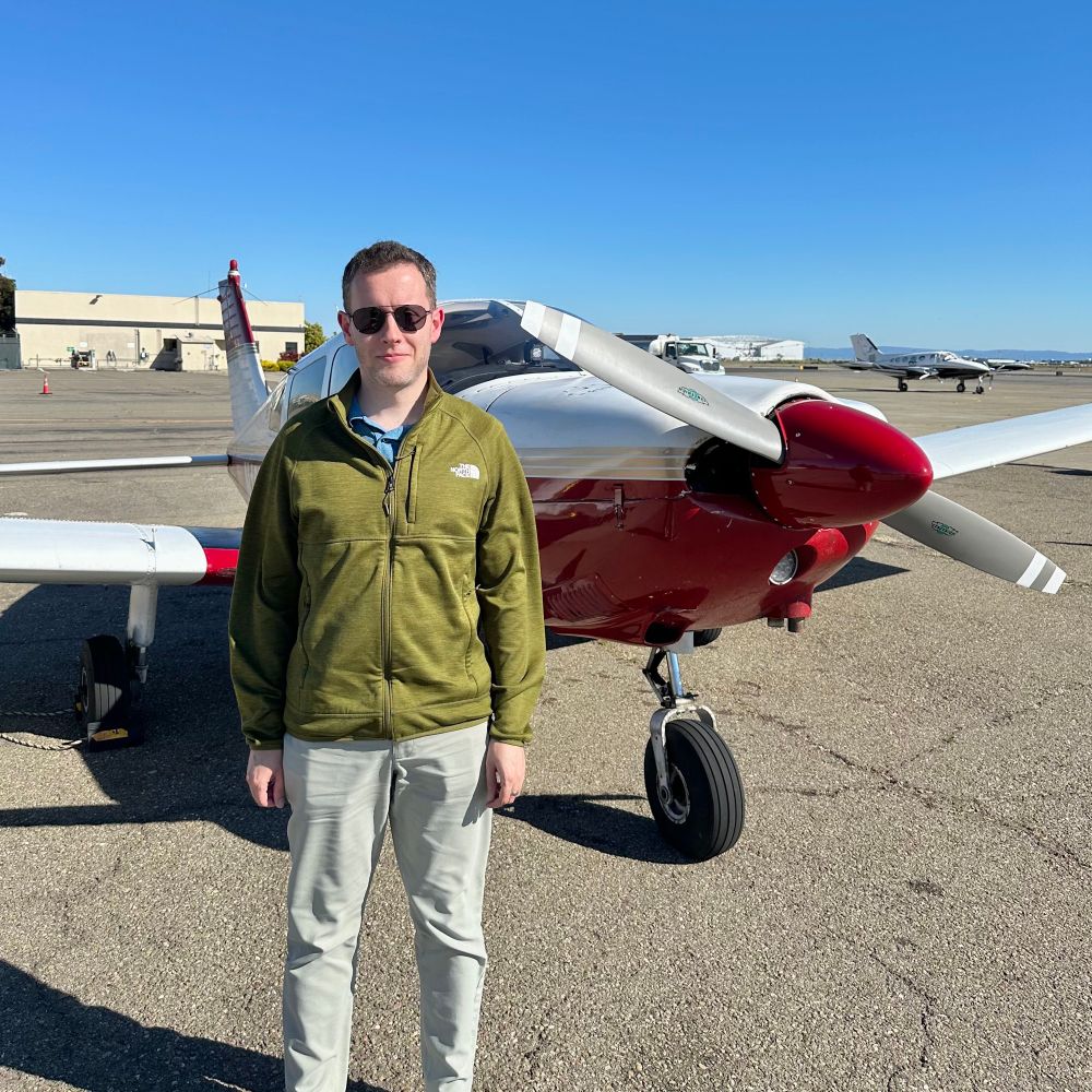 Dimitry standing in front of the plane the instructor didn't let him crash despite Dimitry's best efforts