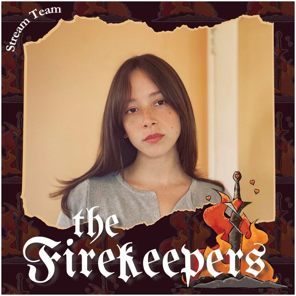a photo of May with a grey shirt and her long hair down, framed by a border with an illustrated sword and bonfire. The text 'stream team' is in the top left of the frame and 'the firekeepers' across the bottom