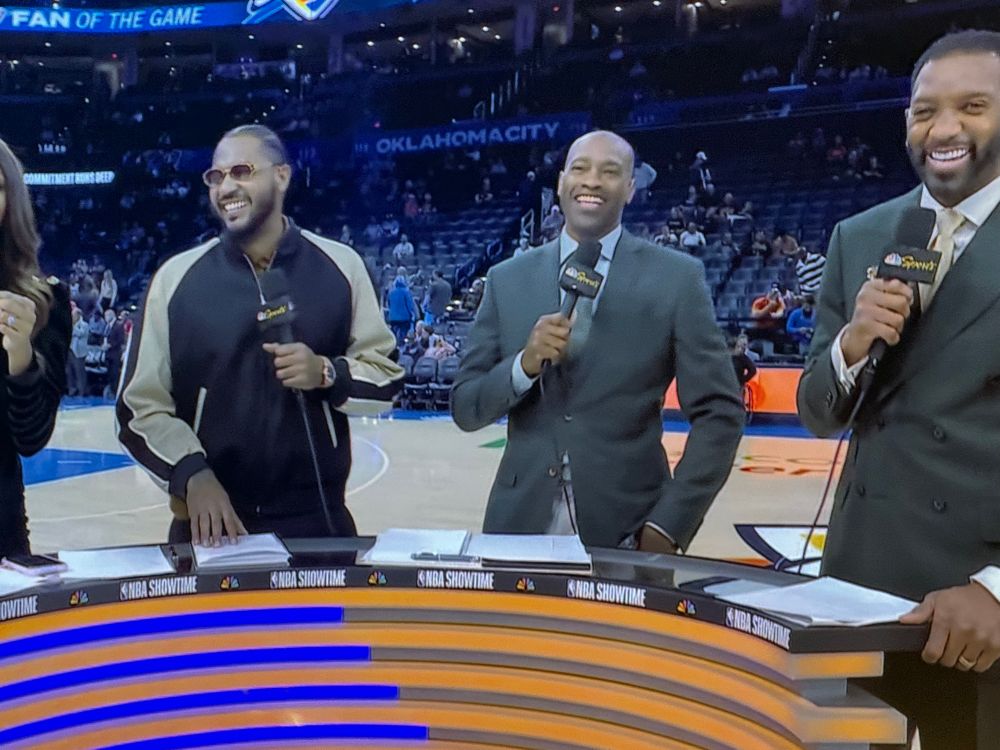 Carmelo Anthony, Vince Carter, and Tracy McGrady on the NBC / Peacock pregame show. Carter and McGrady are wearing suits and Anthony is wearing what looks like a track jacket 