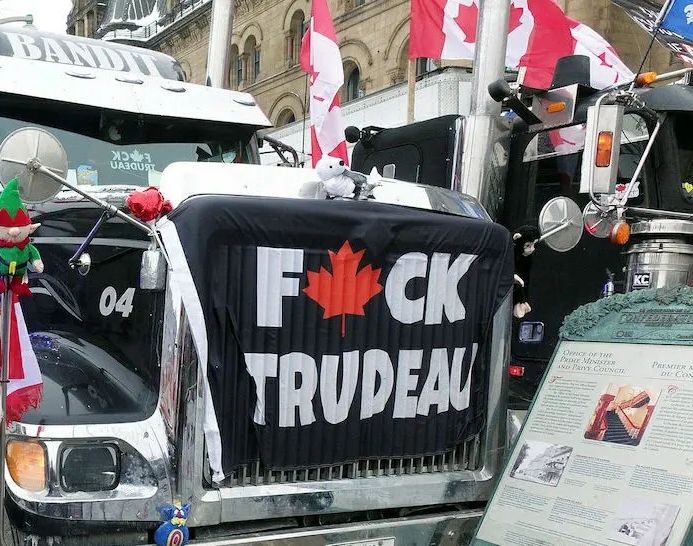 A convoy trucker with the flag Fuck Trudeau