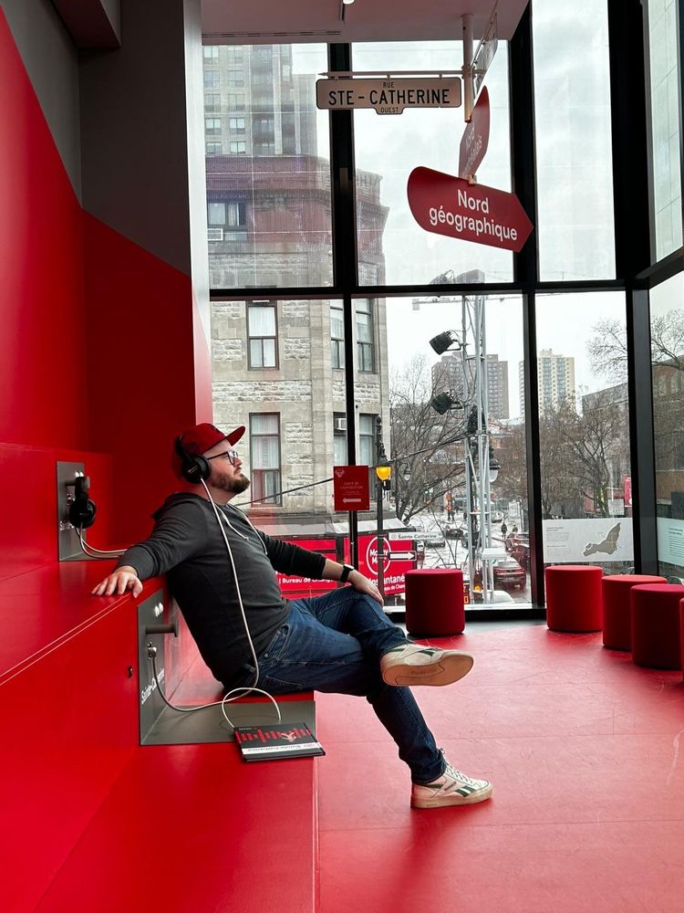At the MEM (Musée des memoires Montrealaises) I'm sitting looking out a big window at the corner of St Catherine and St Denis. A narrated audioguide tells me the history of the streets I'm looking at out the window. I look very cool but that's neither here nor there.