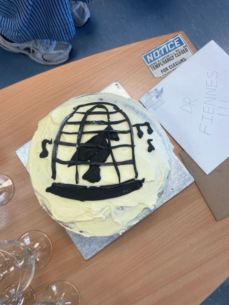Celebratory cake decorated with caged songbird