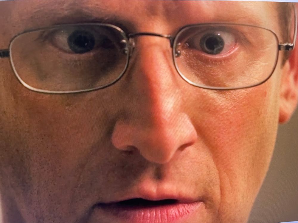 Closeup of Tim Robinson - face with glasses 