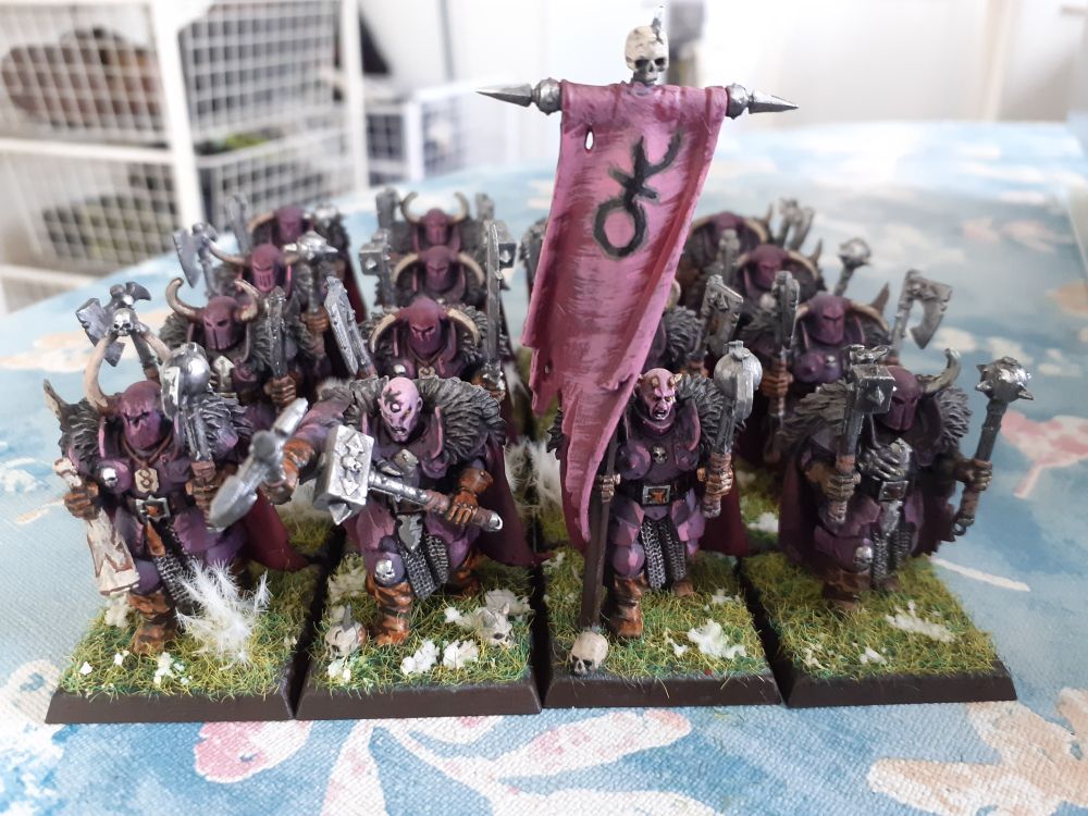 A troupe of axe wielding vikings in the snow.